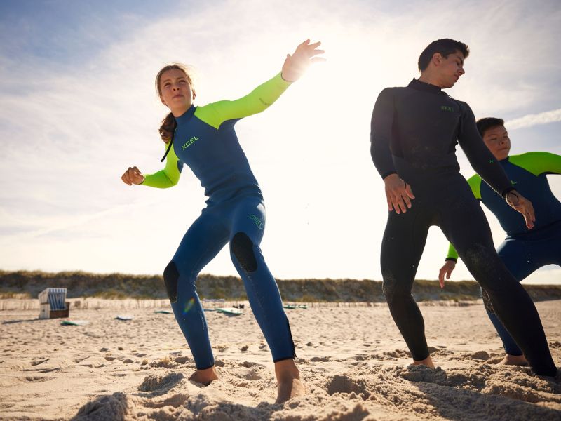 Dry exercises before surfing on the beach.